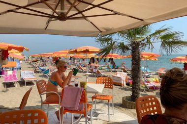 Meer Strand Bar überfüllt Sonnenschirme Frau mit Handy sexy Tanga / Foto: TELOS - XM2490.jpg